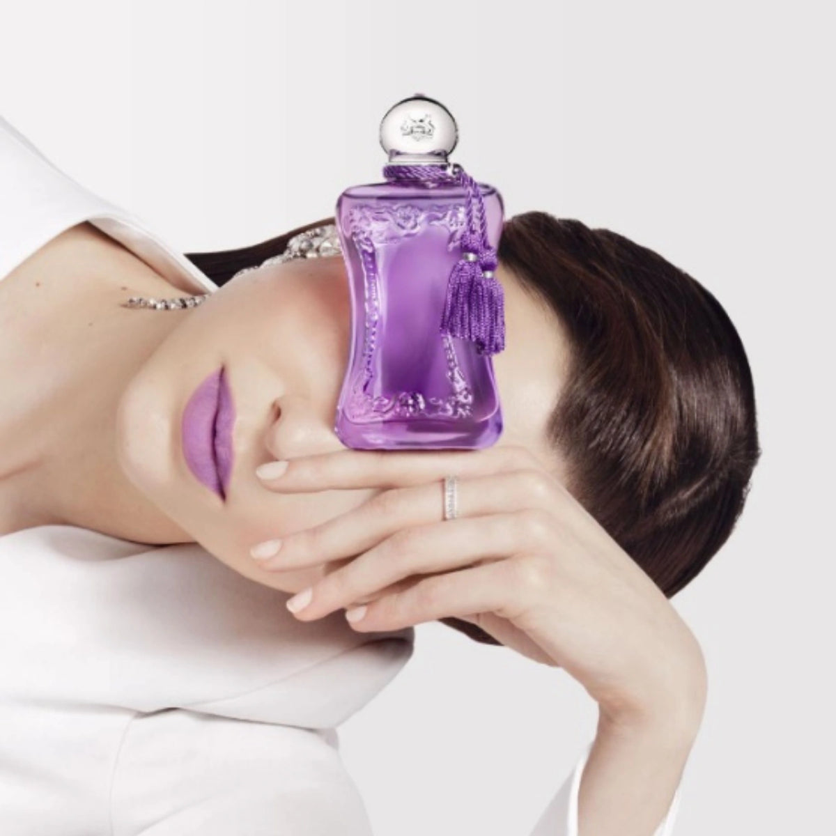 Parfums de Marly Palatine Eau de Parfum bottle styled with a model wearing lavender lipstick, highlighting the fragrance's elegant violet-inspired aesthetic.