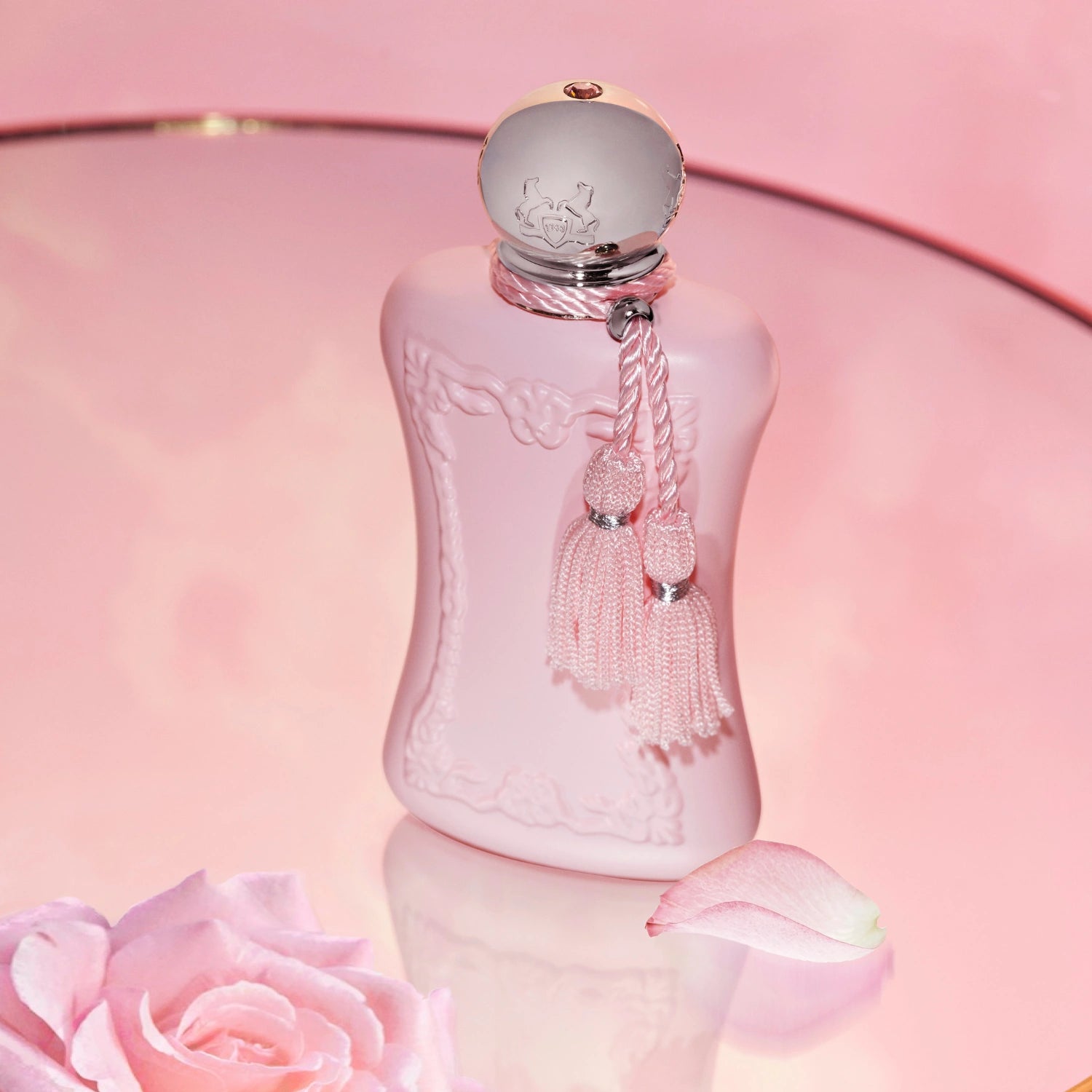 Parfums de Marly Delina Eau de Parfum bottle with a blush pink bottle, silver cap and matching pink tassels.