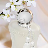 Parfums de Marly Valaya Eau de Parfum bottle with a matte white finish, silver cap, and white decorative tassel.